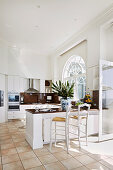 Bright open kitchen with counter and arched windows