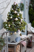 Christmas terrace with sugar loaf spruce and fire bowl