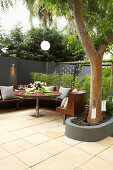 Round bench and table on the terrace under the tree