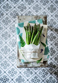 A bundle of green asparagus on a chopping board