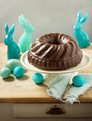 A Bundt cake with chocolate glaze and Easter decorations