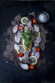 Fresh brook trout with ingredients ready to be roasted