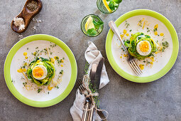 Boiled eggs in leek nests with lemon dressing, sesame seeds and cress