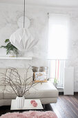 Handmade lamp made from folded wallpaper in bright interior