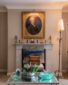 Antique portrait in gilt frame above fireplace in living room