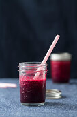 Beetroot juice in a jar with a straw