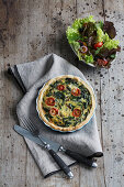 Chard quiche with tomatoes served with a side salad