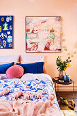 Bedroom in shades of pink and blue with tassel plaid, abstract murals and Christmas decorations