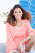 A young woman wearing an apricot blouse