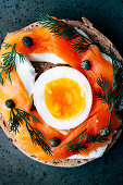 Smoked salmon multigrain bagel with creme fraiche, egg, capers and dill