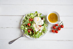 Lettuce with poached eggs and cherry tomatoes