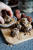 Chocolate date balls rolled in chopped sunflower seeds