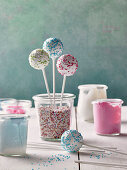 Cake pops with icing and colorful sugar sprinkles