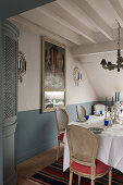 Silverware candlesticks on dining table with corner cabinet with 18th century French trumeau mirror