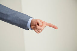 A man's hand pointing with the index finger