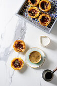 Puff pastry tarts filled with pudding, served with coffee