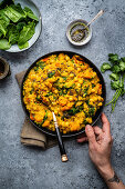 Vegan red lentil, chickpea and squash dahl with spinach in a bowl (India)