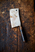 A cleaver on a wooden background