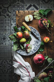 Plate with apples and knife on wooden rustic table