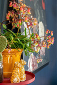 Houseplant and animal ornaments on round side table