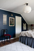 Bohemian bedroom with dark blue wall