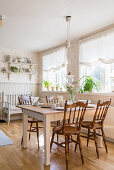 Chairs with turned legs and spindles around table in country-house-style dining room