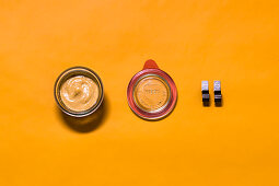 Orange and tahini sauce being stored