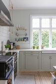 Traditional wood-fired cooker and panelled cabinets in classic kitchen