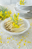 White asparagus with rape seed flowers