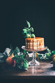A layered apple cake with a caramel topping and apple leaves