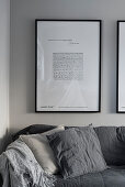 Framed picture above sofa on stone-grey wall