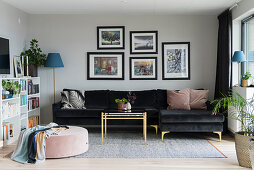 Black velvet couch and brass coffee table in living room