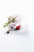 Raw beef steak in parchment paper with spices and rosemary