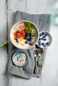 Yoghurt with strawberries, blueberries, oats and mint