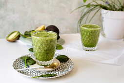 Healthy green smoothie - spinach, avocado and kiwi apple with lemon juice