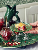 A slice of puff pastry cake with pomegranate