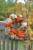 Wreath of rowan berries, hydrangea flowers and rose hips