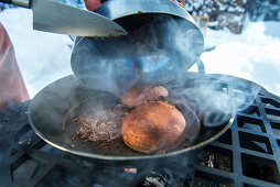 A winter barbecue: portobello mushrooms being smoked on a barbecue (Norway)