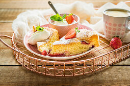 Simple and light sponge cake with fresh strawberries served with cream and mint