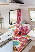Retro-style floral couch in renovated 80s caravan