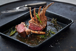 Rack of lamb in a black baking tin