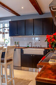 Ceramic sink in modern black-and-white country-house kitchen