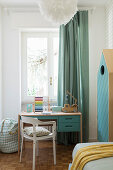 Desk below window in child's bedroom in blue and white