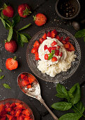 Meringue Nest with cream, strawberries, mint and black pepper