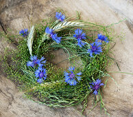 Cornflower and rye ear wreath with grass and straw