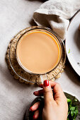 A woman holding a cup of chai tea