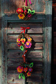 Small willow wreaths decorated with colourful felt flowers and felt hearts