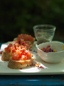 Bruschette with tomatoes and edible flowers