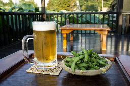 Ice cold beer with salted, cold edamame (Japan)