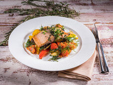 Fried salmon steak with vegetables and herbs